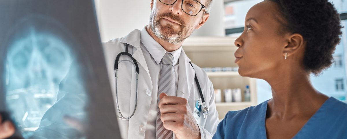 Brain, x ray and neurology doctors in a meeting working on a skull injury in emergency room in a ho