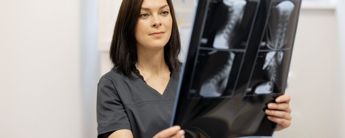 Doctor examines an x-ray of the cervical spine