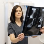 Doctor examines an x-ray of the cervical spine